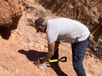 man digging in dry dirt